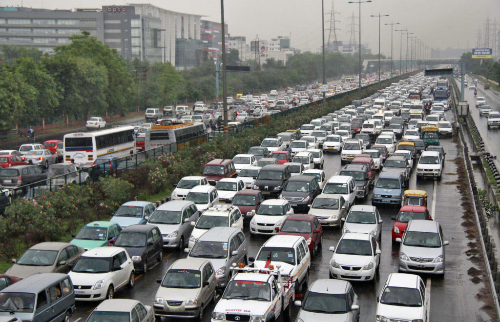 Heavy traffic moves along a busy road as it rains during a power-cut at the toll-gates at Gurgaon on the outskirts of New Delhi